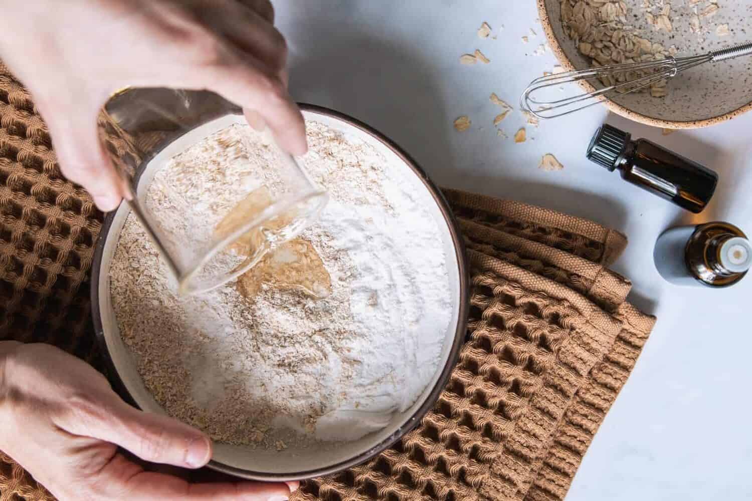Mixing dry and wet ingredients to make diy bath bombs