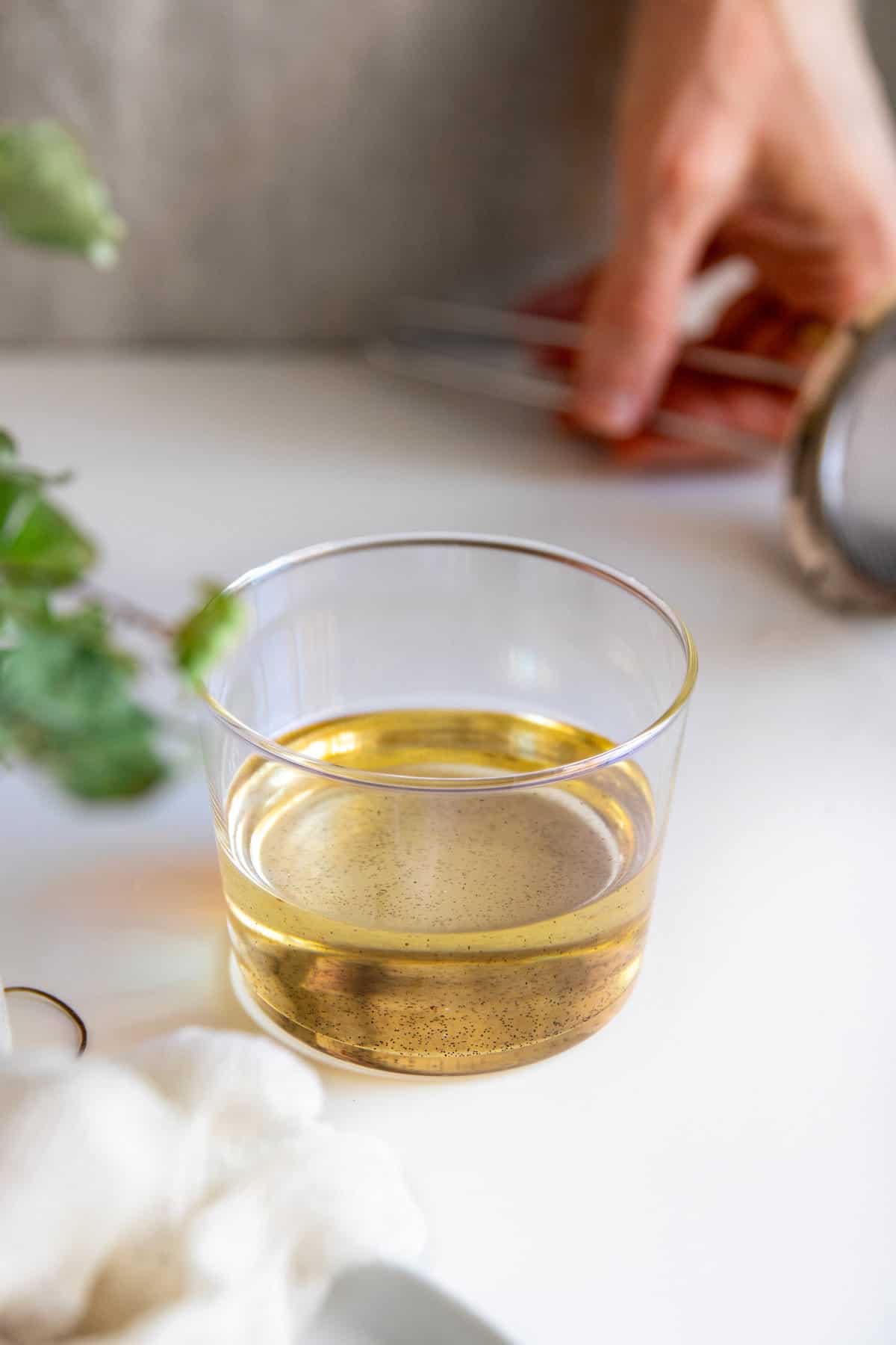 Strain vanilla bean from oil